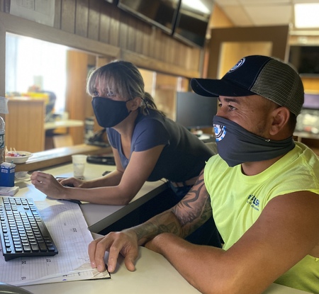 Image of two A Royal Flush employees looking at the computer